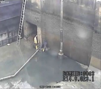 Shock video of two workers overwhelmed by water